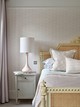 Romantic pink bedroom featuring Carnac Wallpaper in Opal, with rhythmic Bauhaus-style dots and lines.